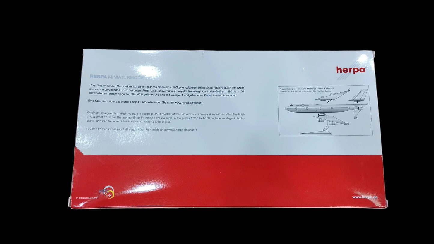 Model airplane packaging with 'herpa' branding on a beige surface