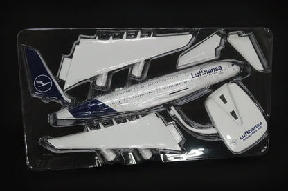 Model airplane parts in a clear plastic package on a desk.