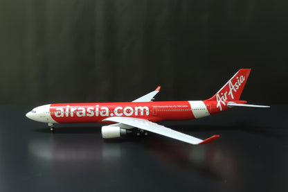 Model airplane with AirAsia branding on a checkered surface