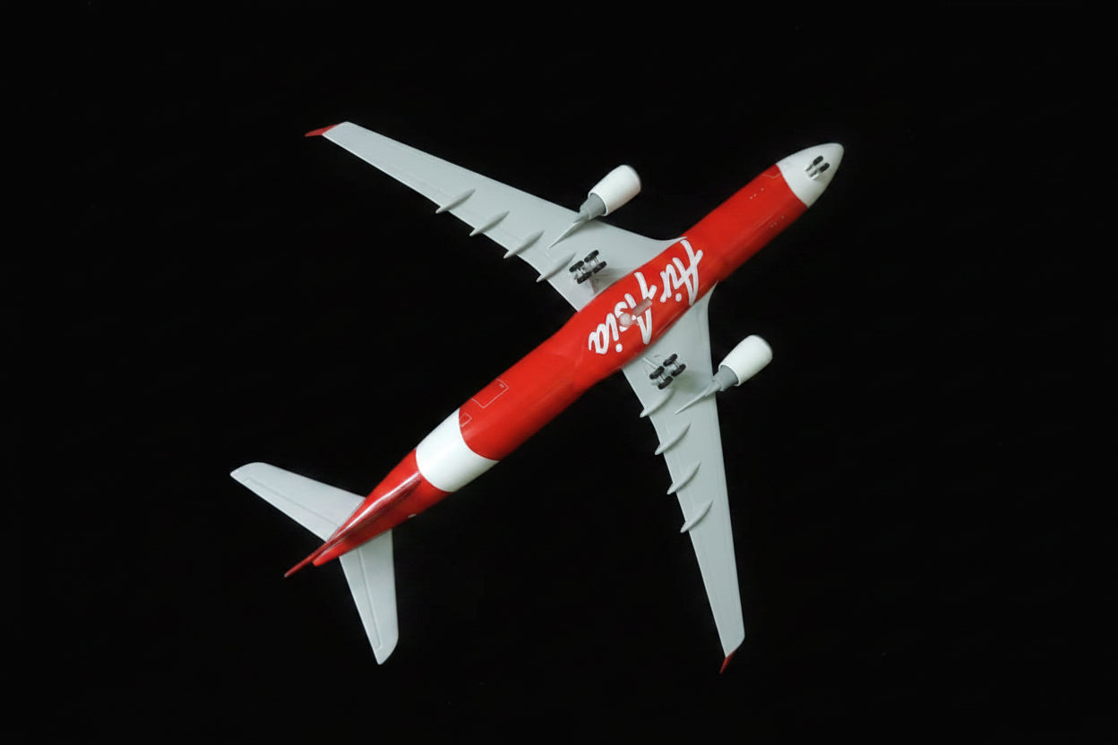 Model airplane with red and white design on a checkered fabric background