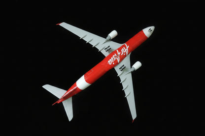 Model airplane with red and white design on a checkered fabric background